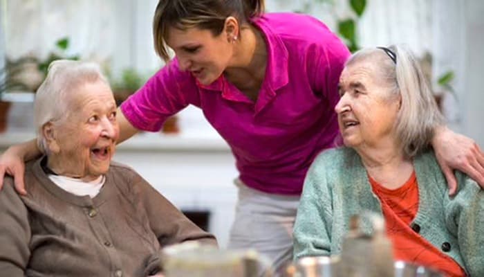 A caring hand resting on an older person's hand